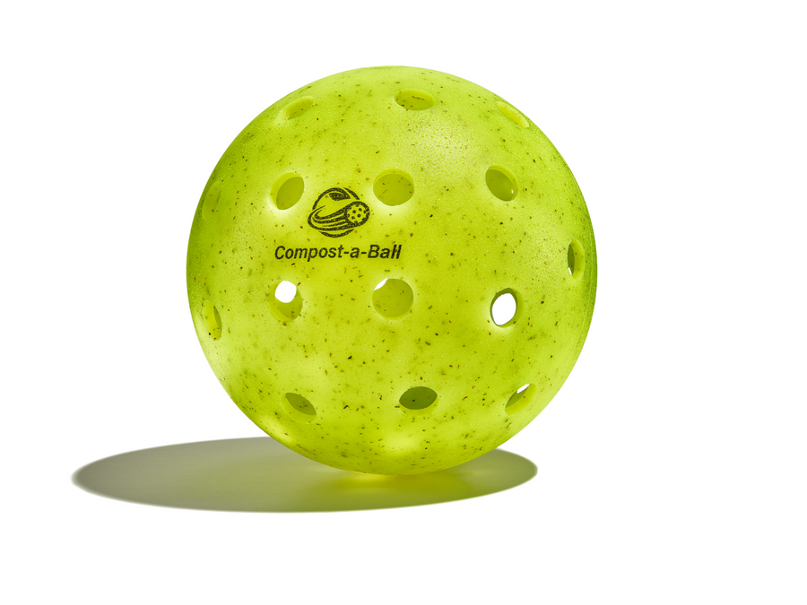 A green yellow compostable pickleball with the brand name 'Compost-a-Ball' printed on it.
